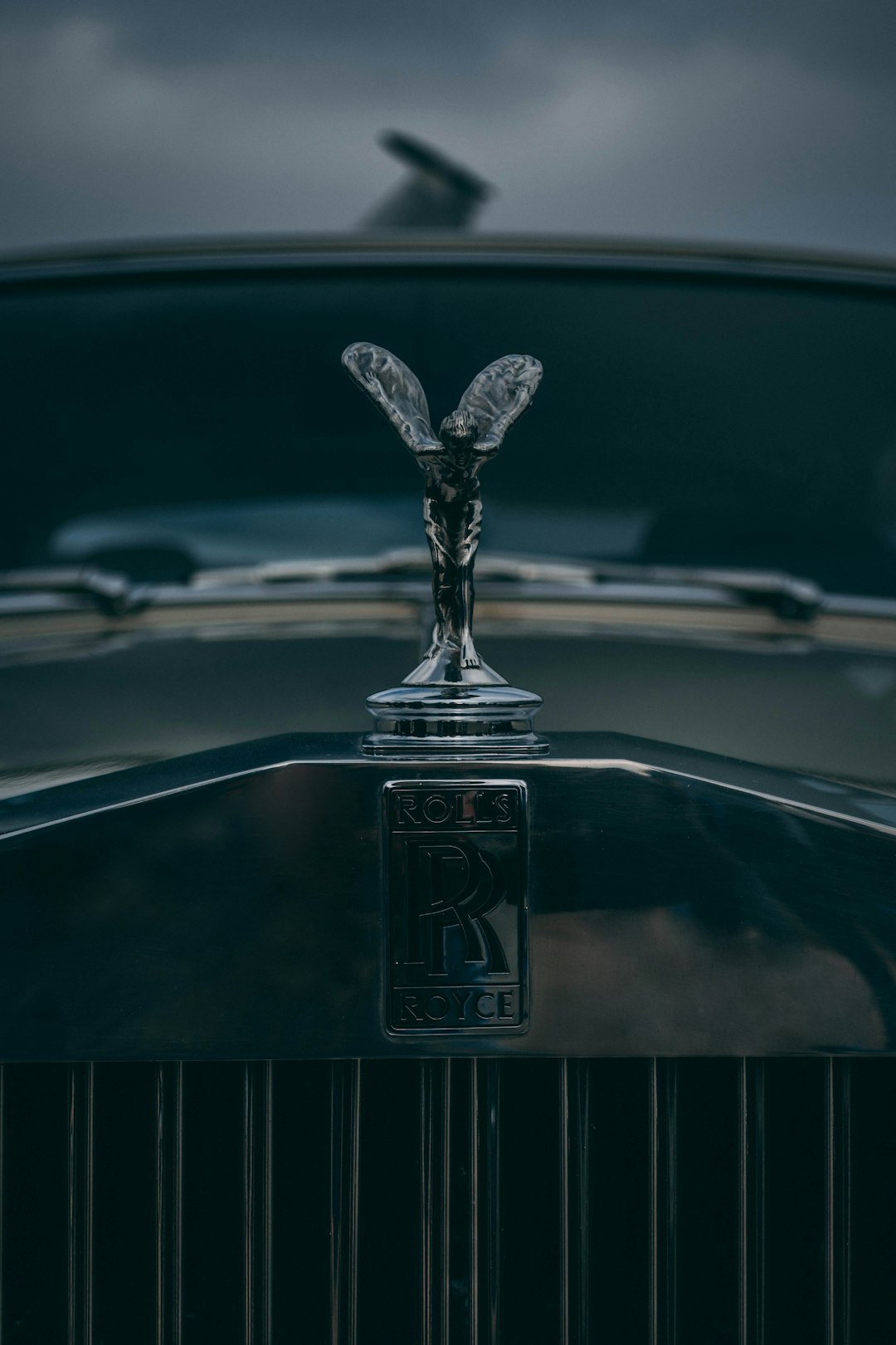 The Glamorous History of Designer Perfumes: From Couture to Fragrance 💃 by Perfume Brands the emblem on the front of a vintage car