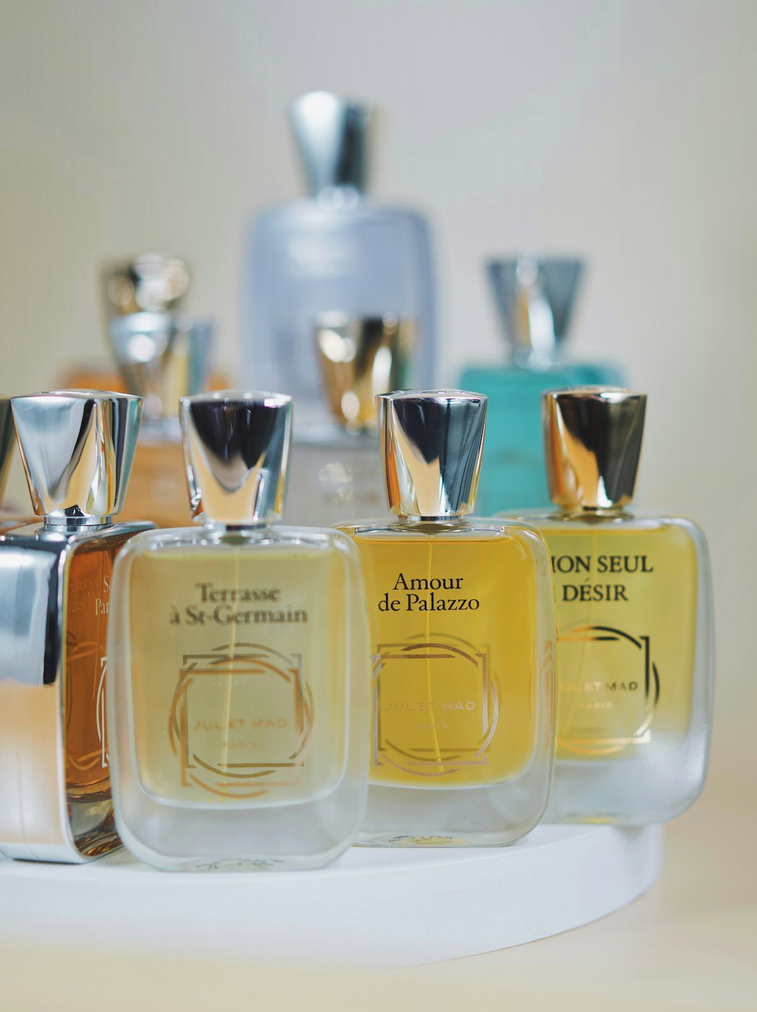 Perfume bottles from the brand Jul et Mad including Terrasse a st germain, amour de palazzo and mon seul desir. by Perfume Brands a group of bottles of perfume sitting on top of a table
